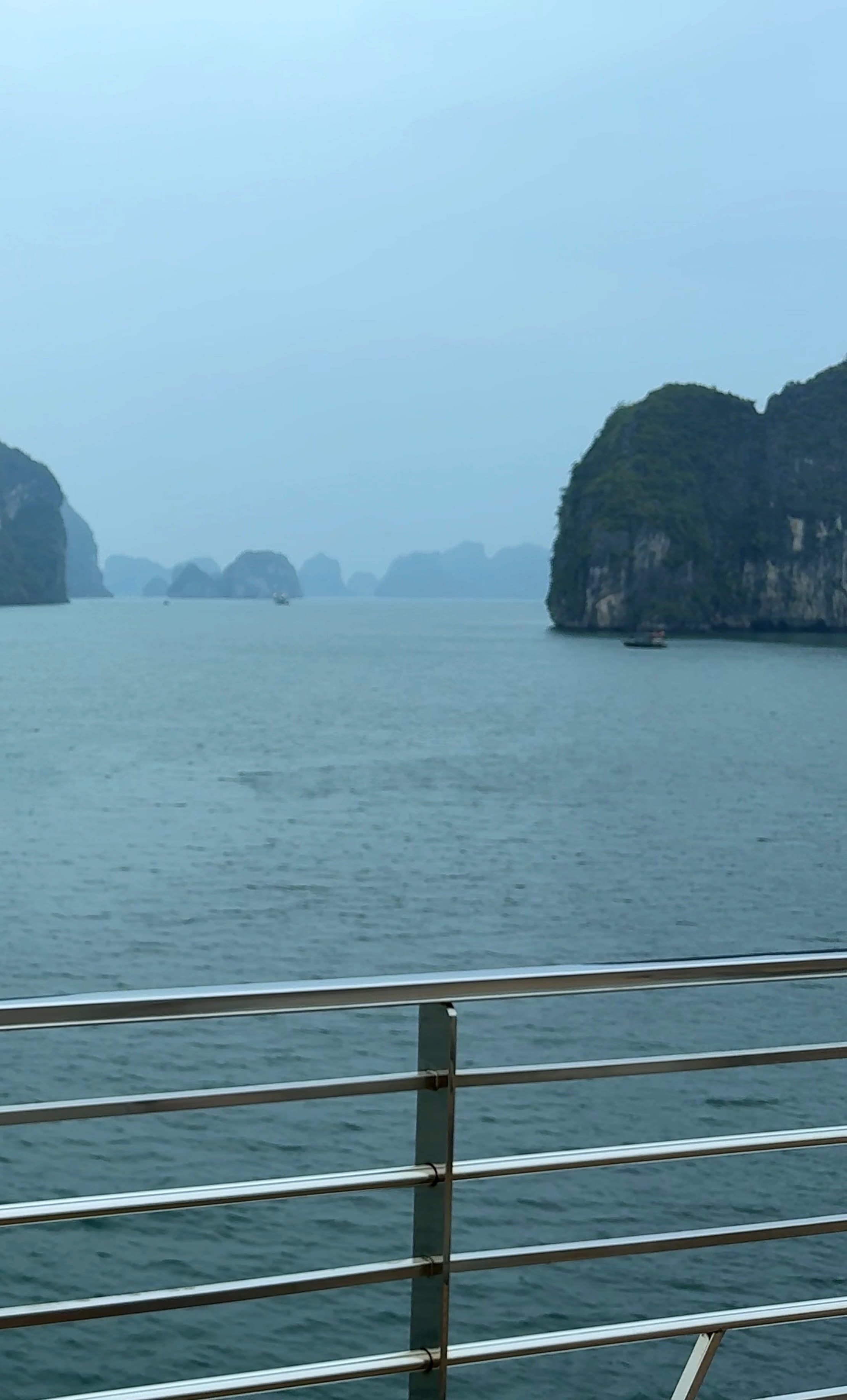 Limestone islands standing in still water at Ha Long Bay