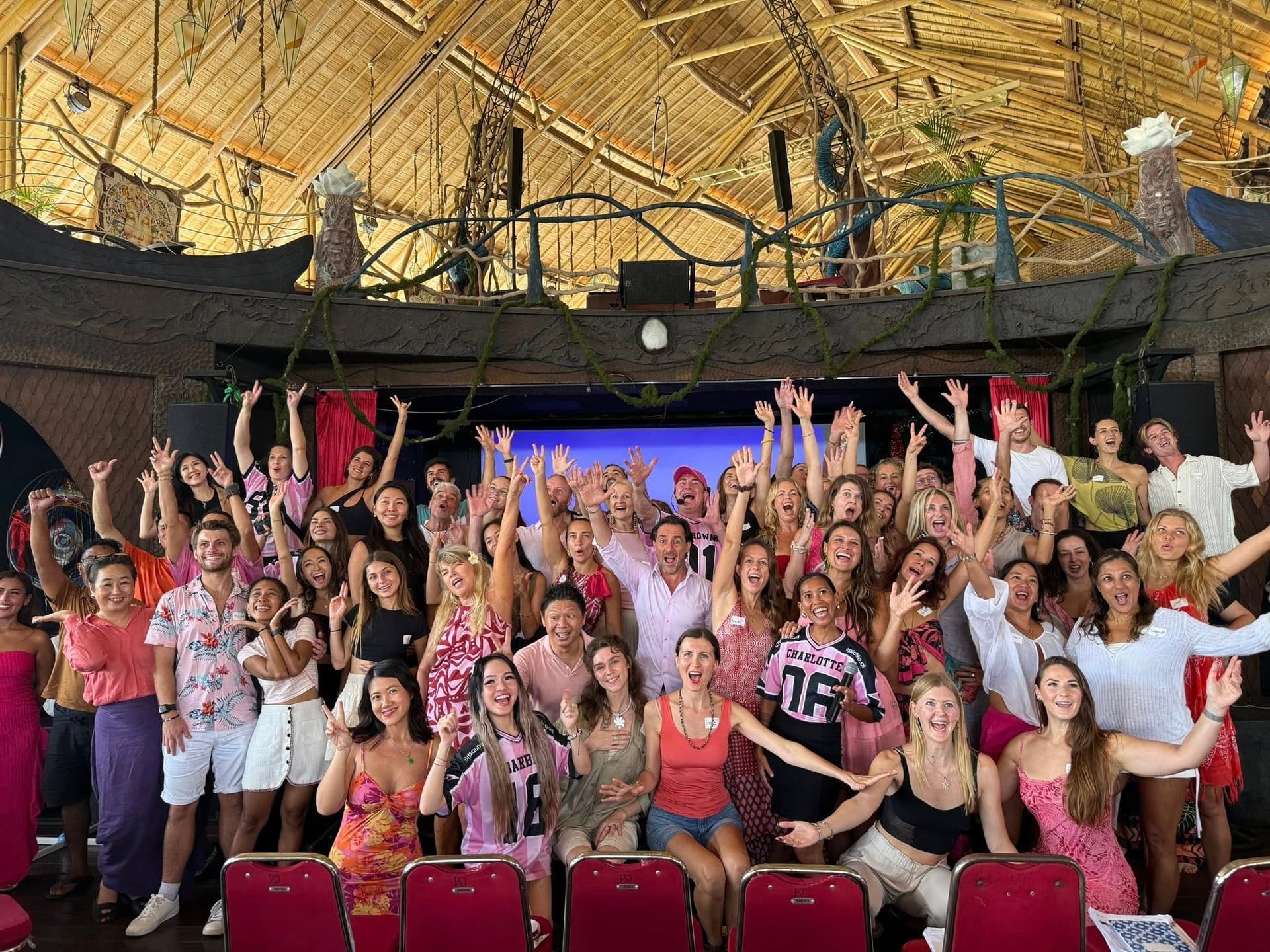 A full room at the close of an Expansion weekend, hands raised